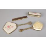 A vintage vanity set featuring floral petit point embroidery. Includes brushes, comb and mirror.