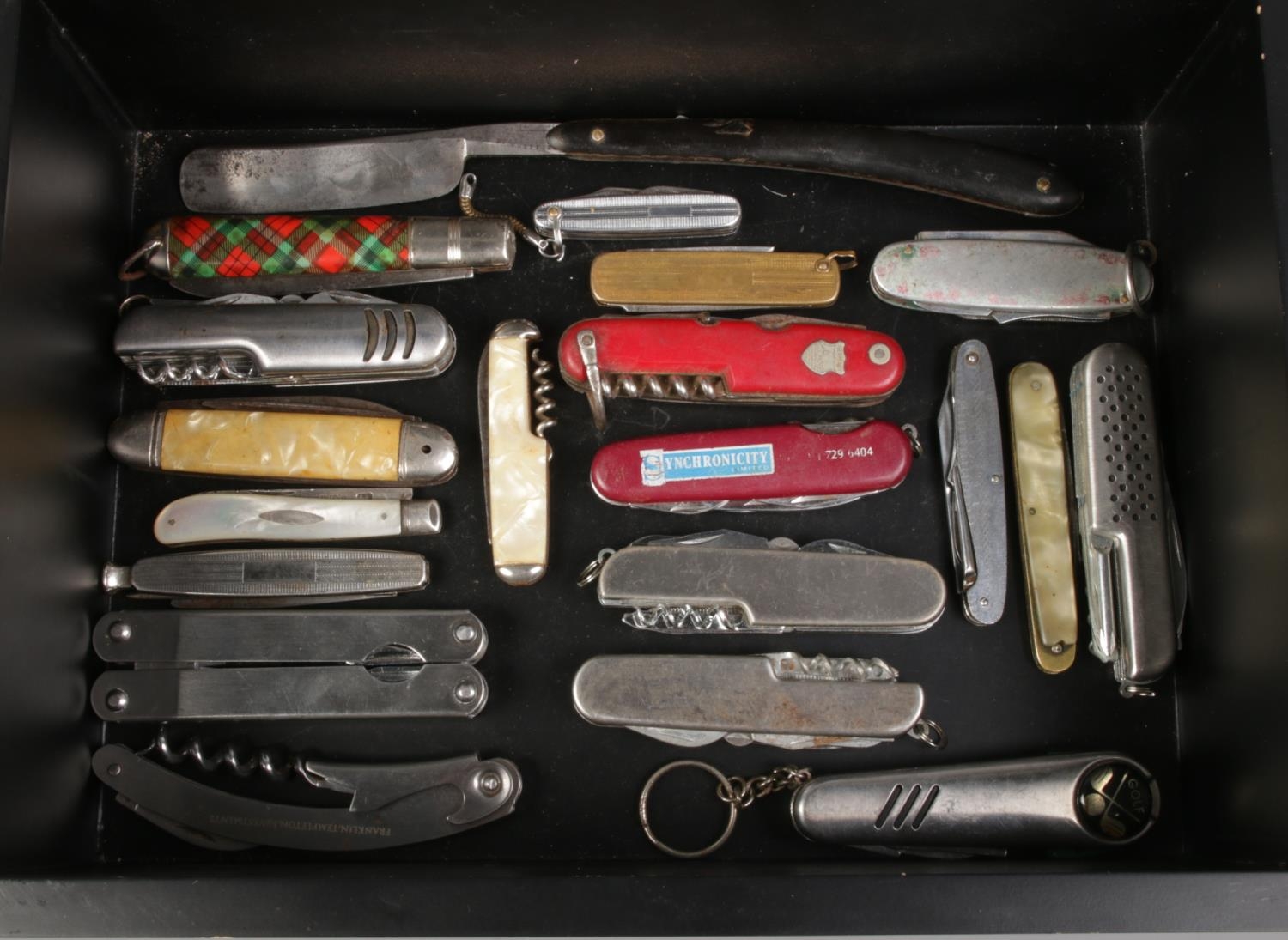 A case containing an assortment of pocket and multi tool knives. To include silver bladed,