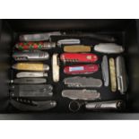 A case containing an assortment of pocket and multi tool knives. To include silver bladed,