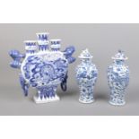 A collection of blue and white ceramics to include tulip vase and pair of baluster lidded vase