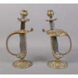 A pair of Naval Officers dress sword hilt candlesticks.