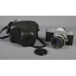 A vintage Nikon Nikkormat camera in original case with Nikkor-H lens.