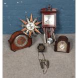A collection of clocks featuring a Highland pendulum wall clock, The Alexander Clark Co mantel clock