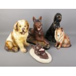 A collection of five large pottery dogs including a wall mount example.