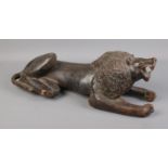 Tribal hand carved lion in recumbent pose. 54cm long