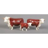 A Beswick Hereford cow trio of figures stamped CH. of Champions to underside. Good condition.