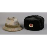A Soviet army Ushanka hat, labelled 62 to the inside, together with a Mybro tweed example.