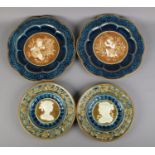 Four Majolica style pottery chargers, impressed with backstamp 'Schutz'. Largest: 39cm.