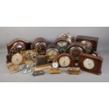 A large collection of assorted clocks including several Smiths Enfield clocks.