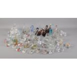 A large collection of glass swans and other glass figures of animals.