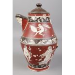 A Greek jug decorated with classical figures and having mask spout. Label to base 'Neopolitan