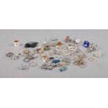 A quantity of costume jewellery rings and pendants including floral, dragonfly and heart examples.