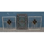 A pair of leaded stained glass windows along with a single example. Single pane 52cm x 33cm. Pair