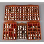 A collection of mainly ceramic and white metal thimbles in five display frames.