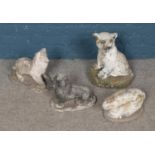 A collection of four reconstituted stone animals including rabbit, lion cub and two dogs.