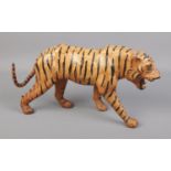 A vintage leather wrapped tiger. 36cm long Good condition.