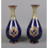 A near pair of Royal Doulton vases featuring blue and green glaze, possibly by Lily Partington.