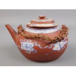A Chinese Yixing teapot decorated in blue and white. Height 11cm, Length 19cm. Damage and repairs to