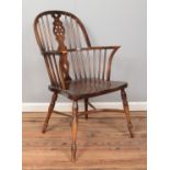 A ash/elm Windsor armchair, with crinoline stretcher and wheelback splat.