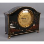 A lacquered mantel clock with chinoiserie decoration and gilt metal mounts. Minute hand loose.