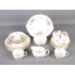 A Royal Crown Derby tea service in the Derby Posies pattern. Includes milk jug, sugar bowl, teacups,