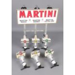 A Martini optics bottle holder wall mount rack with three spare optics.