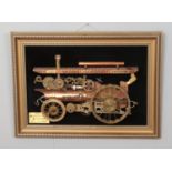 A gilt framed copper and brass train model display in the form of a 1926 Showman Engine by Hurd.