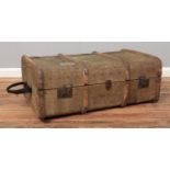 A wooden bound canvas trunk, displaying several luggage stickers and with hinged opening and