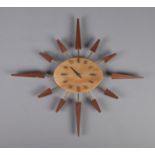 A Manley sunburst quartz wall clock. Hour hand is missing.