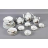 Oriental style china tea set with tea pot, milk jug, serving plates and more.