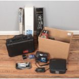 A box of photographic equipment including Elmo Super 106, boxed tripods, lens, hardcase, etc.