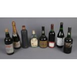 A collection of vintage alcohol including Cockburn's Fine Ruby Port, Moscatel Capital Wine, Cabernet