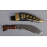 A Nepal khukuri/gurka dagger engraved with dragon motifs. Includes sheath decorated with brass coins
