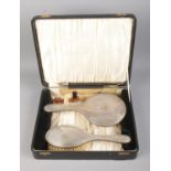 A silver Daniel Manufacturing Company cased vanity set including mirror, brush and comb.