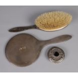 A silver handled vanity mirror and brush along with silver lid. Hallmarks various.