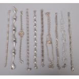 Eleven silver bracelets, to include examples with paste set, weighing scales and heart shaped