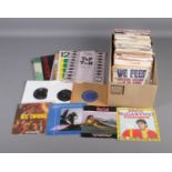A box of vinyl single records of mainly pop and rock examples to include Elvis Presley, The
