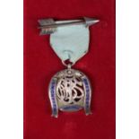 A silver fob on blue ribbon with arrow badge, awarded to PJ Harding, President 1967-68. Assayed