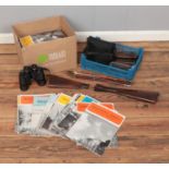A collection of shooting themed accessories including cleaning rods and several stocks along with