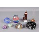 A collection of glassware to include several paperweights and bubble bud vase.