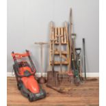 A quantity of assorted garden tools, together with a Flymo Easimo electric lawnmower.