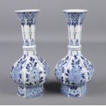 A pair of blue and white Delft vases. Height 21cm. Cracks to neck of one.