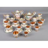 A GV Capodimonte tea service featuring gilt edging and decorated with cherubs. Comprising of cups,
