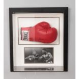 A Muhammed Ali signed boxing glove in presentation case. Approx. case dimensions 51cm x 57cm x 19cm.