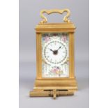 A miniature brass and painted floral enamel carriage clock, by Deacon, Swindon. With key. Height (