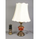 A brass and wooden bodied table light, together with a miners lamp; which has been converted to