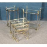 A glass and brass side table with swan design with a similar nest of tables and side table