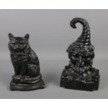 Two cast iron door stops one depicting a cat the other of Punch.