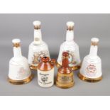 Five Bell's whiskey decanters and a small flagon.