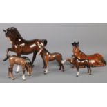 Five Beswick ceramic horses, including sitting, prancing and foal examples. Chip to the ear on the